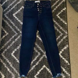 Dark wash skinny jeans with frayed hems